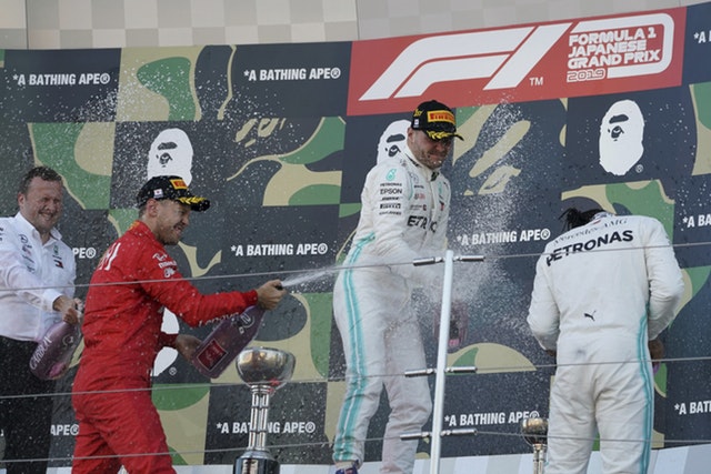 Hamilton, right, shares the podium with Valtteri Bottas, centre, and Sebastian Vettel